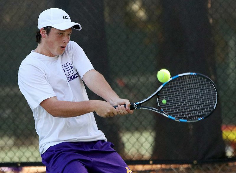 Parker Stearns of Little Rock Catholic returns a shot to Rogers’ Michael Zheng during the Class 7A boys tennis state tournament at Rebsamen Park Tennis Center on Monday afternoon in Little Rock. Stearns moved to the semifi nals with a 6-1, 6-4 victory.