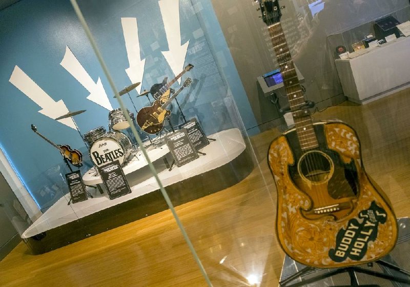 A guitar once owned by Buddy Holly flanks a gathering of instruments similar to what The Beatles once played. The traveling memorabilia exhibit, “Ladies and Gentlemen … The Beatles” opened Oct. 8 at the Clinton Presidential Center and continues through April 2.
