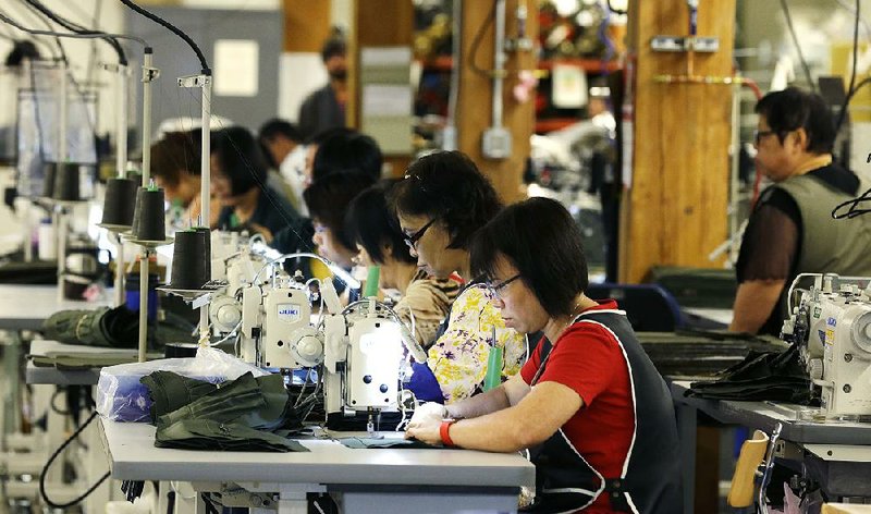 Employees at the C.C. Filson Co. manufacturing facility in Seattle work at their sewing machines in August. The Federal Reserve said Monday that manufacturing output in September rose for the third time in four months.