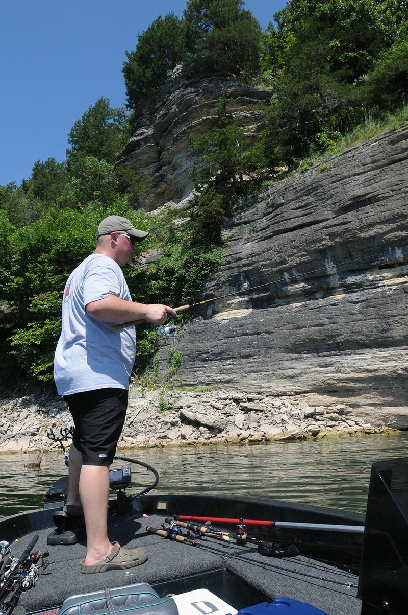 Payton Usrey fishes in August at Eden’s Bluff, one of the sights on the Beaver Lake Aqua Trail.