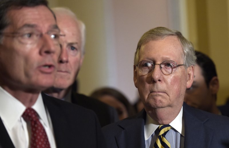 In this Sept. 7, 2016 file photo, Senate Majority Leader Mitch McConnell of Ky. listens at right as Sen. John Barrasso, R-Wyo., left, speaks during a news conference on Capitol Hill in Washington.