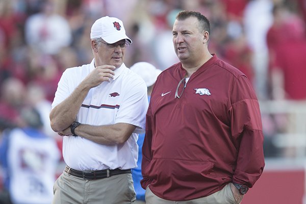 Arkansas secondary coach Paul Rhoads, left, talks with head coach Bret Bielema prior to a game against Ole Miss on Saturday, Oct. 15, 2016, in Fayetteville. 