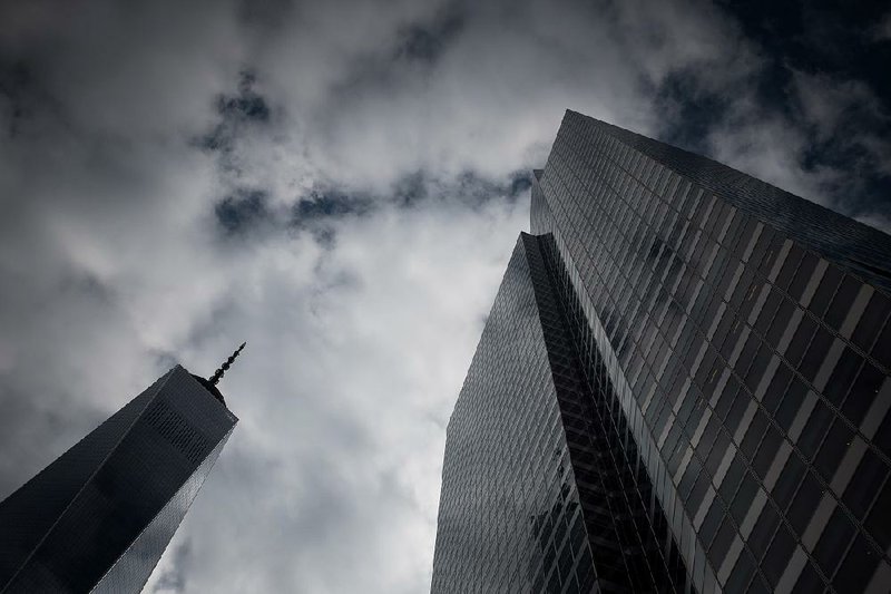 Goldman Sachs Group Inc.’s headquarters (right) stands next to the One World Trade Center tower in New York in this file photo.