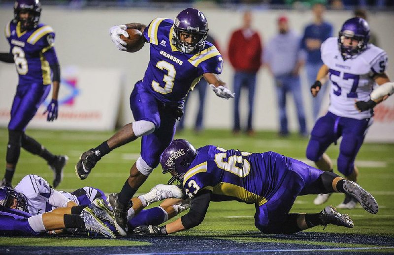 Jaqwis Dancy (3) breaks through the line on a run for Junction City in the 2014 Class 2A championship game against Hazen. Dancy, now playing at Louisiana Tech, has been diagnosed with Hodgkin’s Lymphoma, a treatable cancer that starts in white blood cells. 