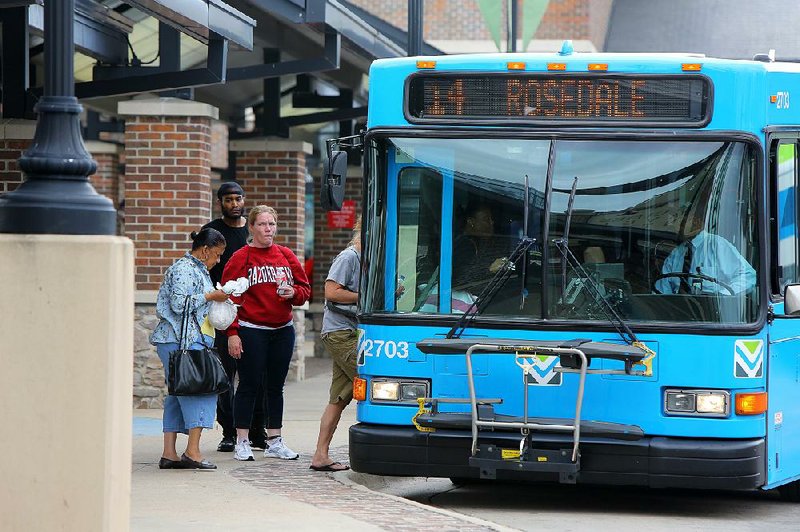 Passengers board a Rock Region Metro bus Tuesday at the River Cities Travel Center in downtown Little Rock. The transit agency on Tuesday announced a plan to help area voters get to the polls on Election Day. 