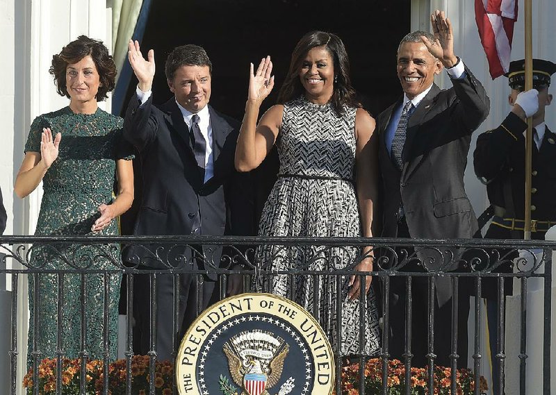 President Barack Obama, first lady Michelle Obama, Italian Prime Minister Matteo Renzi and his wife, Agnese Landini, greet onlookers Tuesday from the Truman Balcony of the White House.