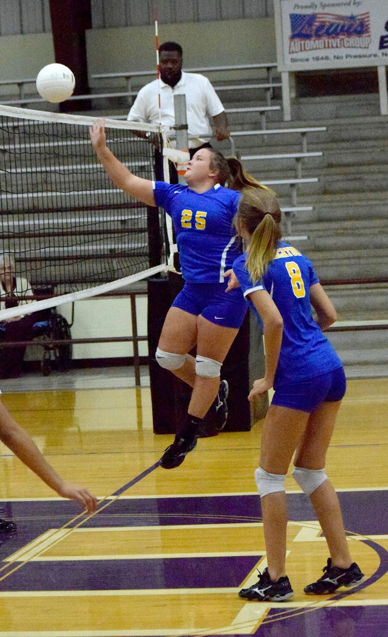 Photo by Mike Eckels In her last regular season appearance, senior Cameron Shaffer tips the ball over the net and into open court for a Bulldog point during the Decatur-Elkins senior girl&#8217;s&#8217; volleyball match at Elkins High School Oct. 13. The match marked the final conference match of the 2016 season for both teams.