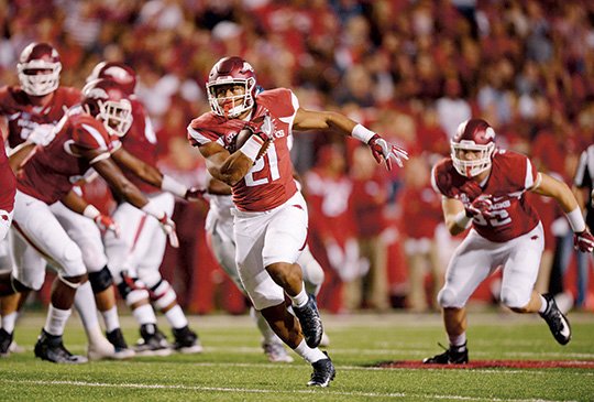 NWA Democrat-Gazette/Ben Goff ROOM TO RUN: Arkansas running back Devwah Whaley (21) carries the ball against Ole Miss during the first half of an NCAA college football game on Oct. 15. Whaley finished with 65 yards on 11 carries as the Razorbacks won 34-30.