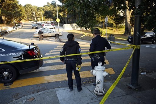 San Francisco Police stand at the site of a shooting outside the June Jordan School for Equity and City Arts and Technology High School, which share a campus, in San Francisco, Calif., Tuesday, Oct. 18, 2016. Several teenage students were shot in the shared parking lot of the two San Francisco high schools Tuesday, and one of the students is in critical condition, authorities said. 