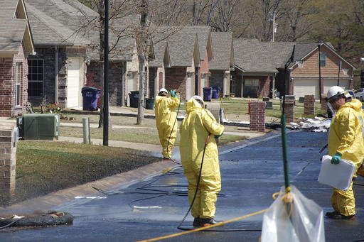 In this April 1, 2013 file photo, crews work to clean up oil in a Mayflower, Ark., neighborhood after an oil pipeline ruptured and spewed oil over lawns and roadways. Attorneys for landowners along the crude oil pipeline that ruptured in 2013 are asking a federal appeals court to reinstate their case. Landowners sued Exxon Mobil Pipeline Co., in 2013, alleging a breach of contract, but the case was dismissed in 2015. Oral arguments will be held Wednesday, Oct. 19, 2016, in Minnesota. 