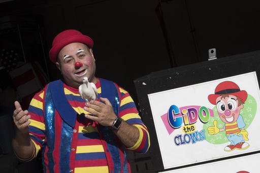 Cyrus Zaveih, also known as Cido the Clown, poses for a photo, Tuesday, Oct. 18, 2016. A spate of scares involving people doing menacing things while dressed in clown costumes has been no laughing matter for real clowns. Some clowns who perform at parties and other private events complain that bookings have fallen off amid creepy clown sightings, some of which have been revealed to be hoaxes.