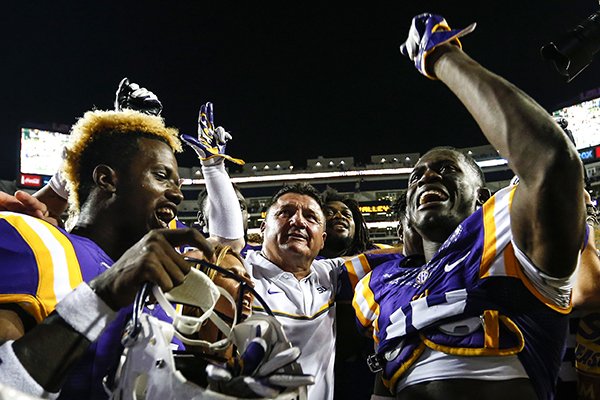 LSU wide receiver Malachi Dupre (15), coach Ed Orgeron, and cornerback Tre'Davious White (18) sing the alma mater after an NCAA college football game, Saturday, Oct. 15, 2016, in Baton Rouge, La. LSU defeated Southern Miss 45-10. (AP Photo/Butch Dill)

