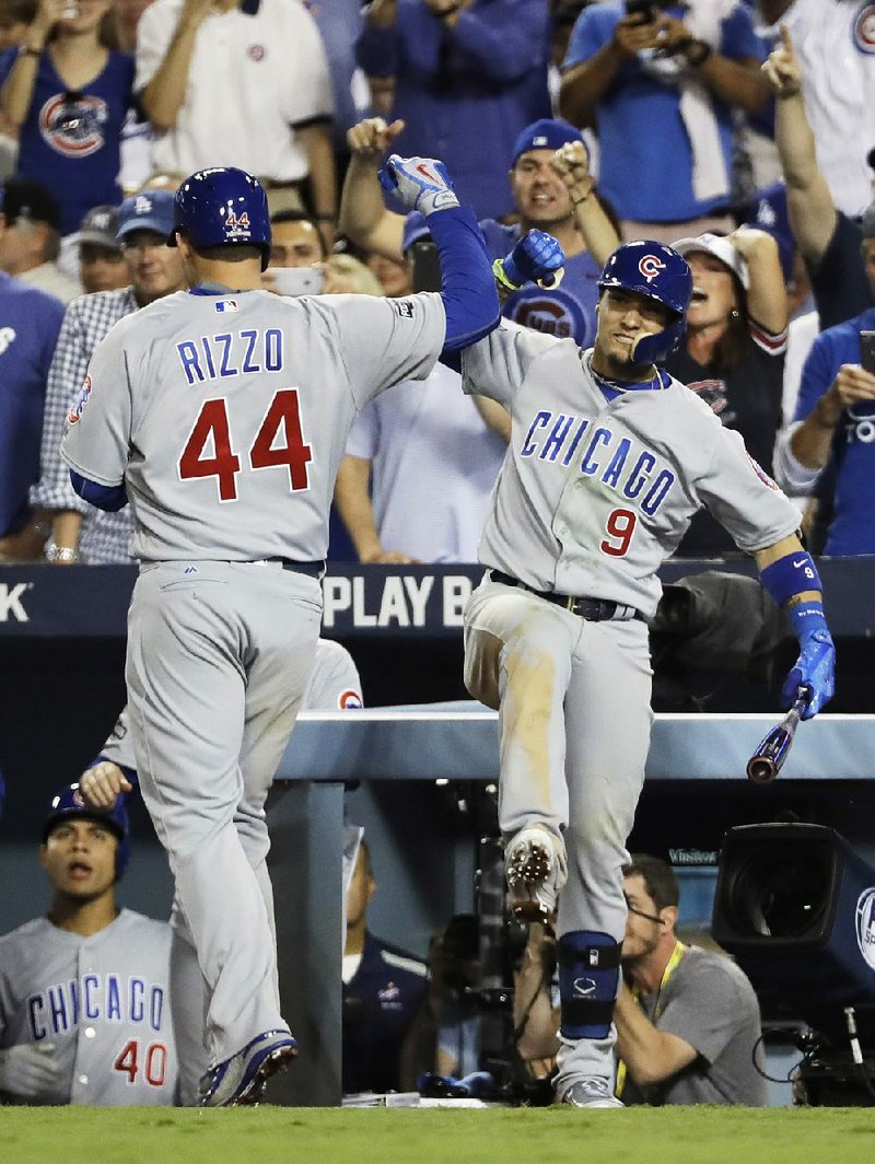 Chicago first baseman Anthony Rizzo is congratulated by second baseman Javier Baez after hitting a home run during the fifth inning of the Cubs’ 10-2 victory over the Los Angeles Dodgers on Wednesday in Game 4 of the National League Championship Series in Los Angeles. Rizzo went 3 for 5 with 3 RBI and 2 runs scored in the Cubs’ victory.