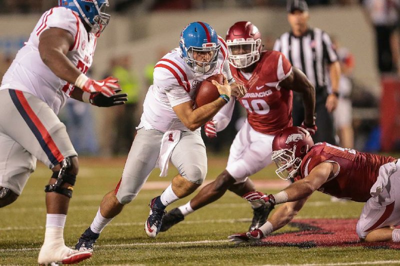 Mississippi Rebels quarterback Chad Kelly (10) tucks the ball and rushes for a gain against the Arkansas Razorbacks during the second half of an NCAA football game Saturday, Oct. 15, 2016, in Fayetteville, Ark. Arkansas beat Mississippi, 34-30. (AP Photo/Chris Brashers)
