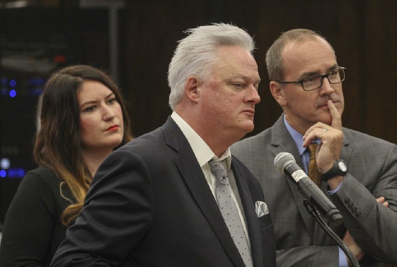 Martin Schoppmeyer (center), Hass Hall founder and superintendent, and staff members Heather Holaway (left) and Mark Henry, ask the Arkansas Department of Education Charter Authorizing Panel to expand the school’s campus to Rogers. The charter school has campuses in Fayetteville and Springdale.