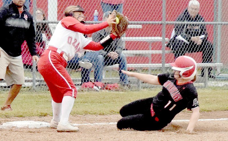 PHOTO BY RICK PECK McDonald County&#8217;s Kylie Helm slides into third base with a triple before Ozark third baseman Tara McCormack can get a tag on her during the Lady Tigers 5-2 win on Oct. 13 at MCHS in a Missouri Class 4 sectional softball playoff game.