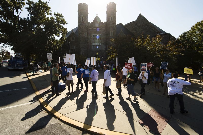 Faculty and their supporters demonstrate at West Chester University in West Chester, Pa., Wednesday, Oct. 19, 2016. Faculty at Pennsylvania state universities went on strike Wednesday morning, disrupting classes midsemester after contract negotiations hit an impasse. 