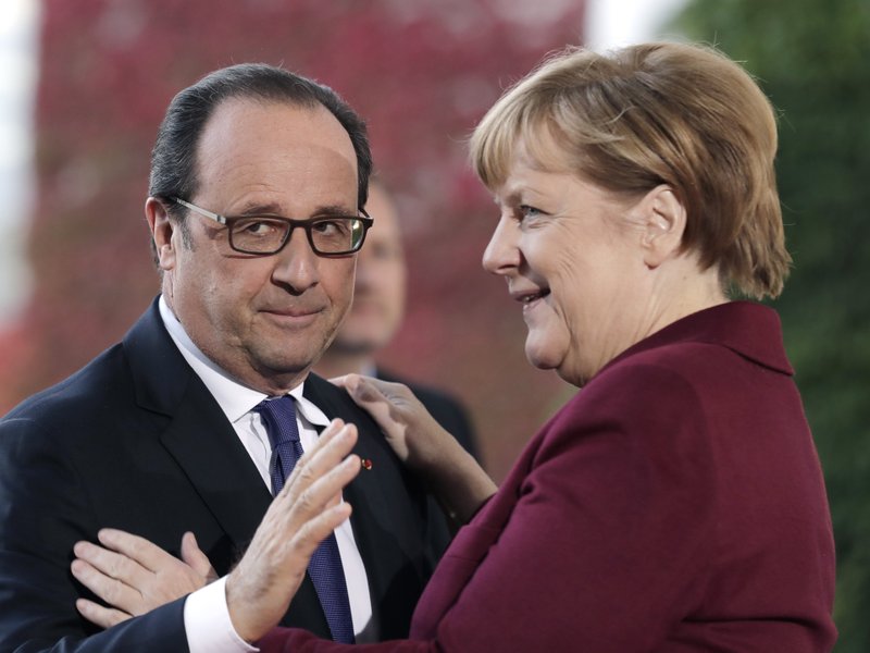 German Chancellor Angela Merkel welcomes the President of France Francois Hollande for a summit with the leaders of Russia, Ukraine and France at the chancellery in Berlin, Wednesday, Oct. 19, 2016. 