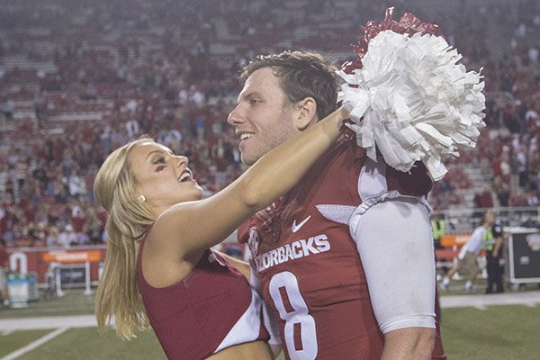 Arkansas quarterback Austin Allen is hugged by a cheerleader following a game against Ole Miss on Saturday, Oct. 15, 2016, in Fayetteville. 