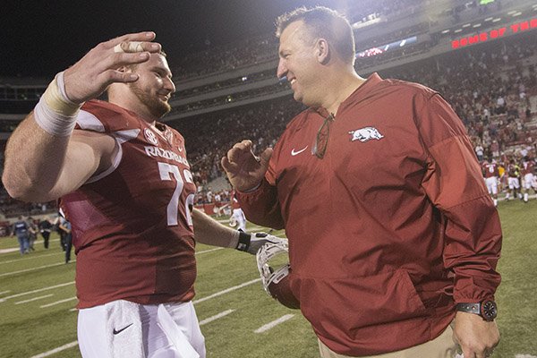Arkansas coach Bret Bielema, right, is greeted by offensive lineman Frank Ragnow following a game against Ole Miss on Saturday, Oct. 15, 2016, in Fayetteville. 