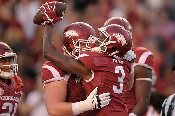 Arkansas receiver Dominique Reed is congratulated after scoring a touchdown during a game against Ole Miss on Saturday, Oct. 15, 2016, in Fayetteville. 