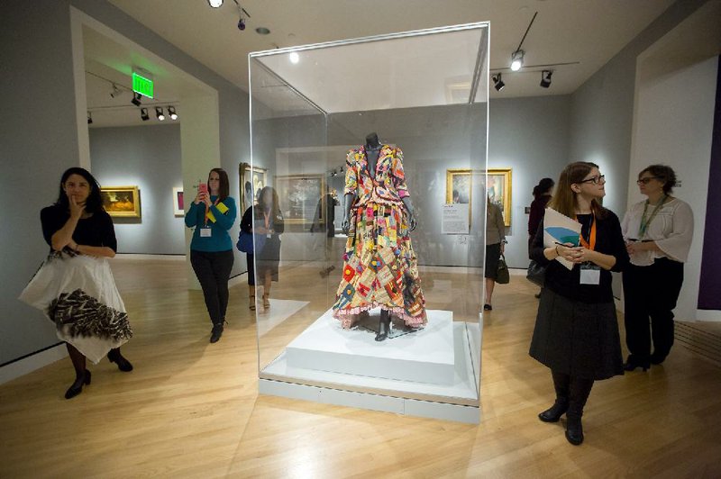 Visitors tour “The Art of American Dance” exhibit Thursday at Crystal Bridges Museum of American Art in Bentonville. The exhibit opens to the public Saturday and runs through Jan. 16.