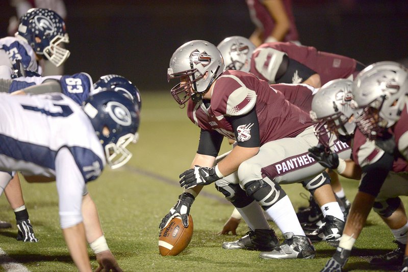 Siloam Springs center Connor Broyles (center) lines up against Greenwood on Oct. 7 at Panther Stadium in Siloam Springs.