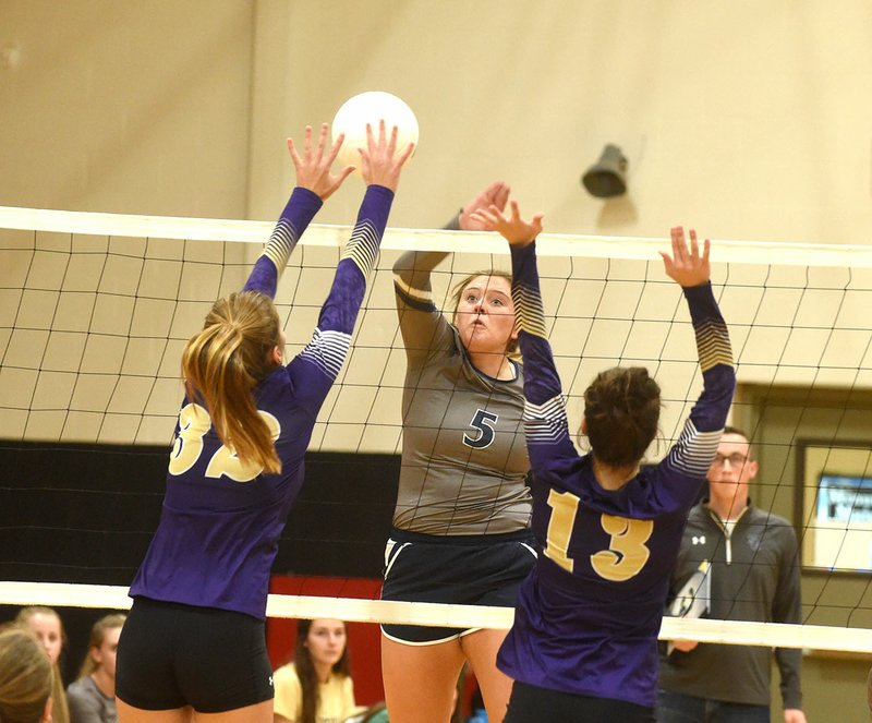 Shiloh Christian’s Olivia Barnes (5) tries to knock the ball past Berryville’s Jeanessa Smith (32) and Allie Ashford (13) on Thursday during the championship game of the 4A-1 Conference tournament at Pea Ridge High School.