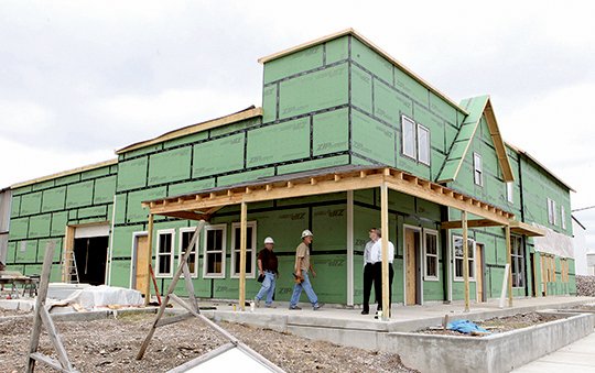 The Sentinel-Record/Richard Rasmussen UP FROM VALLEY: The first phase of renovations to a former warehouse as part of an expansion project for Samaritan Ministries is scheduled to be completed next month. The east end of the facility at the corner of Sanford and Valley streets will house six retail shops after the second phase of construction is completed.