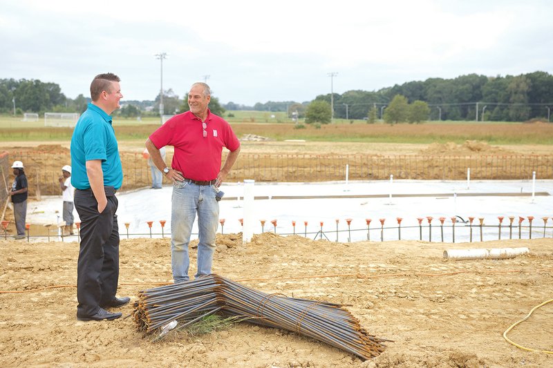 Mike Parsons, left, director of Searcy Parks and Recreation, talks with Clay Brumett, project superintendent for Hydco Construction, about the progress of the $5.1 million public-pool complex.