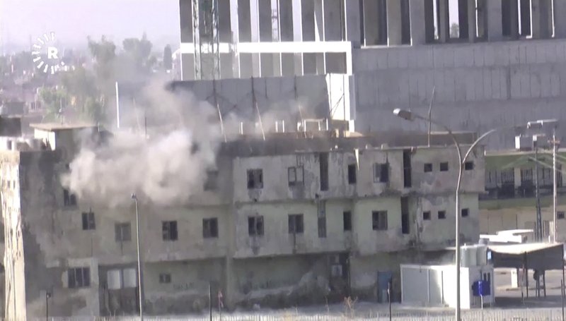 In this image made from video, smoke rises from a building where two militants are believed to be holed up, according to Rudaw TV, in Kirkuk, Iraq, Friday, Oct. 21, 2016. Militants armed with assault rifles and explosives attacked targets in and around the northern Iraqi city of Kirkuk early on Friday in an assault quickly claimed by the Islamic State group and likely aimed at diverting authorities' attention for the battle to retake IS-held Mosul. (Rudaw TV via AP)
