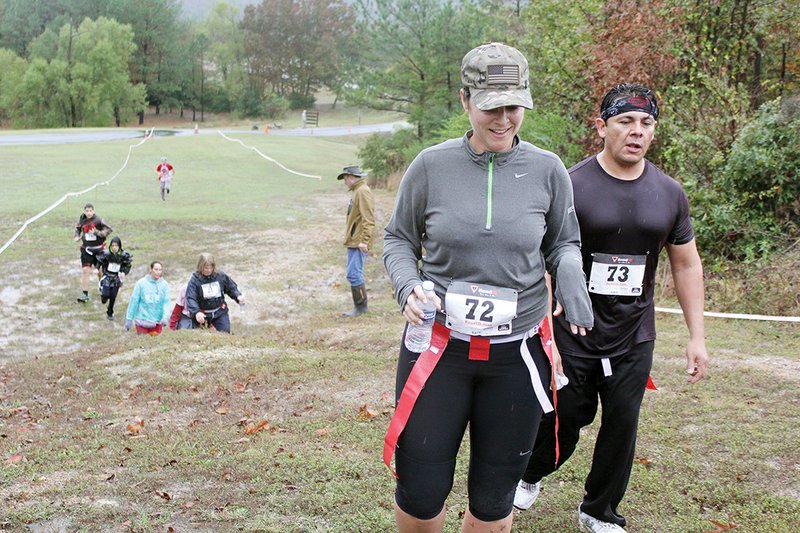 Participants Stacie Cordell and Jorge Gomez make their way through last year’s Zombie Run 5K in Hot Springs to benefit the United Way of Garland County. The fun run will take place Saturday and, weather permitting, will include more obstacles and zombie fun than last year’s inaugural race.