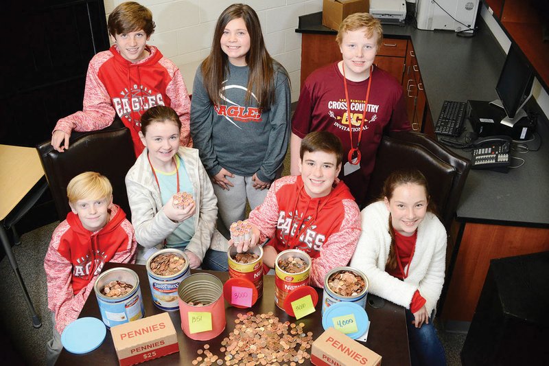 Tate Smithhart, from top left, Grace Shannon and Lucas Yarbrough, along with Ty Heslep, bottom left, 
Hannah Johnson, Gabriel Goodwin and Emma Duncan, are shown last school year with thousands of pennies they gathered in the One Cent, One Life project to promote awareness of the Holocaust. The
students had planned to collect 6 million pennies to represent the number of Jews killed — put 1.5 million on display and donate the rest to the Jewish Foundation of Arkansas. However, Vilonia Middle School Principal Lori Lombardi said she and Superintendent David Stephens agree that the 1.5 million pennies — $15,000 — should be spent on a memorial. Lombardi said the money takes up too much room and is a liability to have at the school.