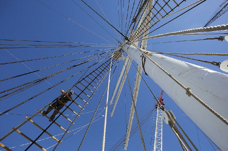 A worker finishes restoration on the Wavertree, a historic three-mast sailing ship that is the new centerpiece of New York’s renovated South Street Seaport Museum. 