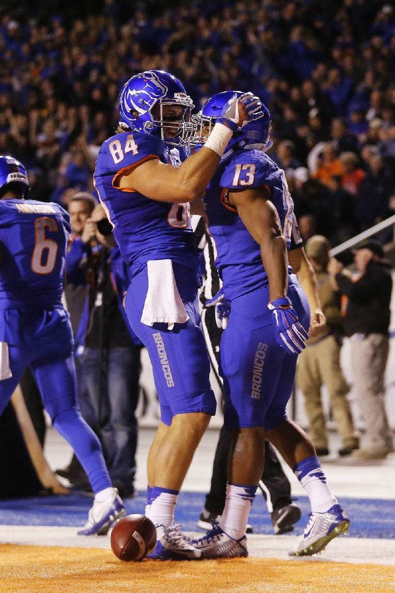 Boise State running back Jeremy McNichols (13) and tight end Jake Knight (84) celebrate a touchdown by McNichols during the first quarter Thursday night against BYU in Boise, Idaho.
