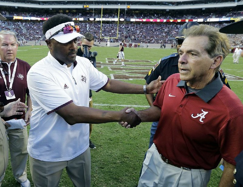 Alabama Coach Nick Saban (right) and Texas A&M Coach Kevin Sumlin greet each other after the Crimson Tide’s 41-23 victory in College Station, Texas, last year. The two teams are tied atop the SEC West standings, and today’s game might go a long way in determining which team remains in position to gain a berth in the College Football Playoffs.