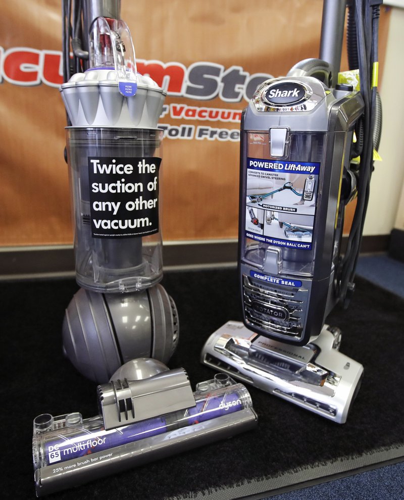 A Dyson, left, and SharkNinja upright vacuum cleaners are positioned together at the evacuumstore.com retail location in Braintree, Mass., Thursday, Oct. 20, 2016. 