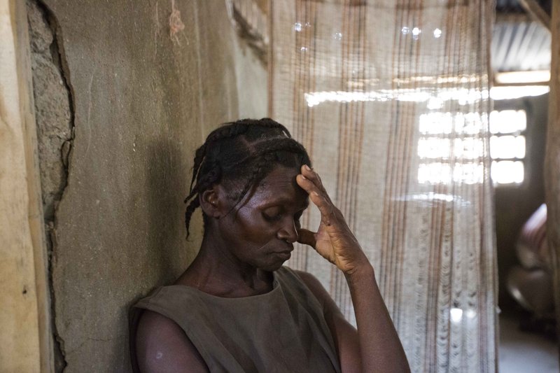 Bertha Mesilier leans Tuesday against a wall in the room she shared with her now missing husband Edma Desravine, who was last seen seeking refuge from the heavy rainfall and winds brought by Hurricane Matthew, in Port-a-Piment, a district of Les Cayes, Haiti. Family and neighbors near the town of Port-a-Piment have dug by hand through wreckage and scoured the riverbanks, but to no avail.