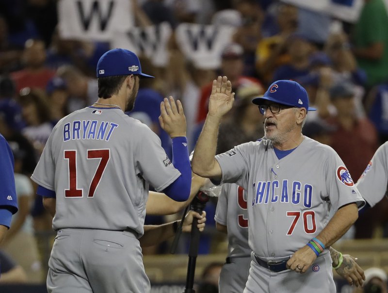 The Associated Press GOING HOME HAPPY: Manager Joe Maddon celebrates with third baseman Kris Bryant after the Chicago Cubs beat the Los Angeles Dodgers 8-4 Thursday night for a 3-2 lead in the National League Championship Series. Chicago seeks its first NL pennant since 1945 when the Dodgers visit Wrigley Field for Game 6 tonight.