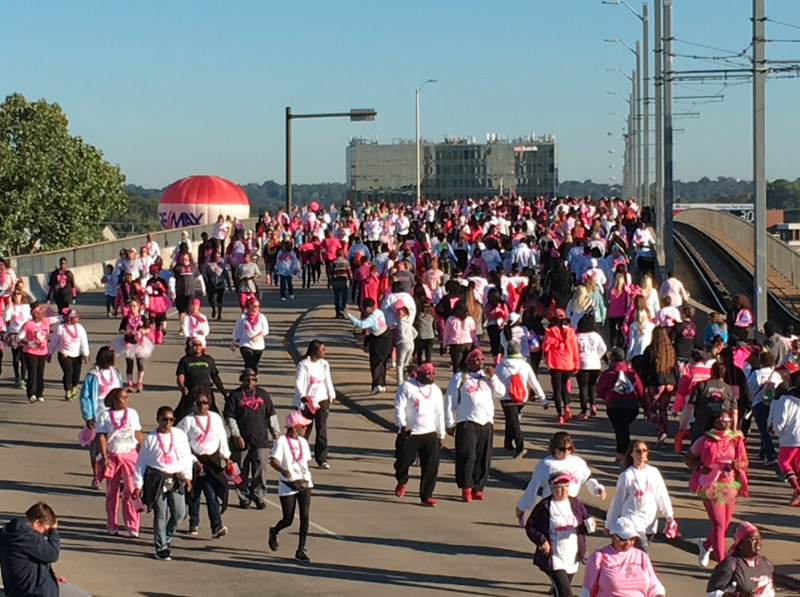 Participants in the 23rd annual Komen Race for the Cure cross the Main Street bridge between Little Rock and North Little Rock Saturday morning.
