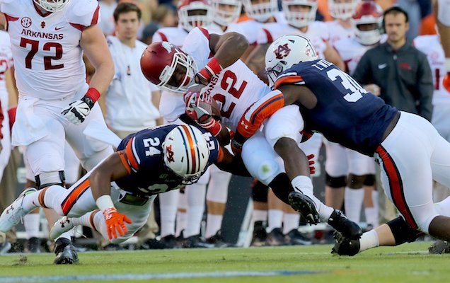 Arkansas' Rawleigh Williams (22) fights for yardage but is brought down during the first quarter of their game Saturday at Jordan-Hare Stadium in Auburn, Ala.