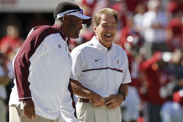 Texas A&M head coach Kevin Sumlin, left, meets with Alabama head coach Nick Saban, right, before an NCAA college football game, Saturday, Oct. 22, 2016, in Tuscaloosa, Ala. (AP Photo/Brynn Anderson)