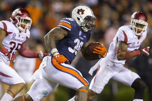 Auburn running back Kamryn Pettway (36) looks to get by Arkansas linebacker Dwayne Eugene (35) (left) and defensive back Santos Ramirez (9) on Saturday, Oct. 22, 2016, at Jordan-Hare Stadium in Auburn, Ala.