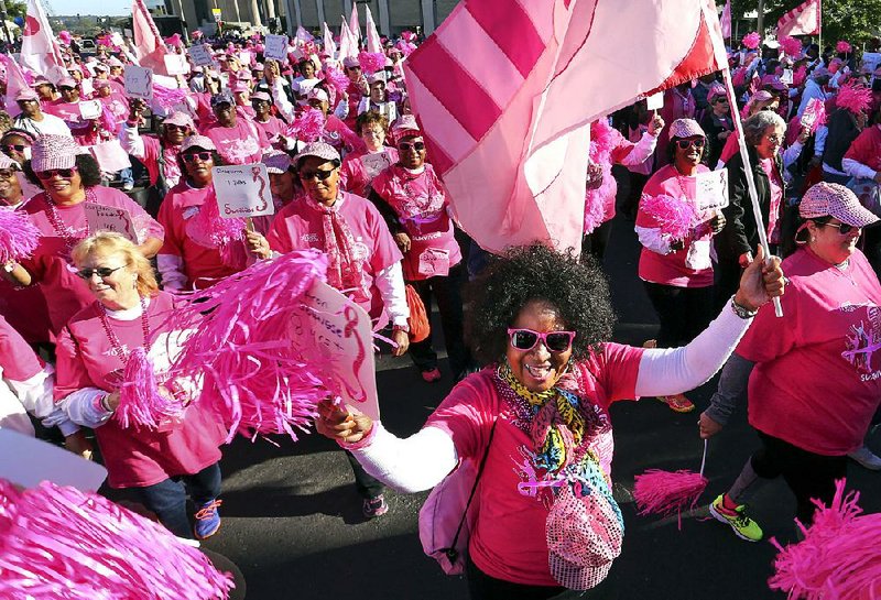 Sharon Johnese (center) and other breast cancer survivors march Saturday morning in the Komen Arkansas Race for the Cure survivors parade in Little Rock. More than 20,000 people participated in this year’s event to raise money and awareness in the fight against breast cancer. More photos are available at arkansasonline.com/galleries.