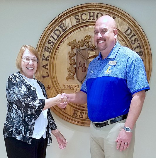 Submitted photo The Oaklawn Foundation's School Wellness Program donation to the Lakeside School District was recently accepted by Superintendent Shawn Cook, right, from Jane Browning, executive director of the United Way of Garland County.