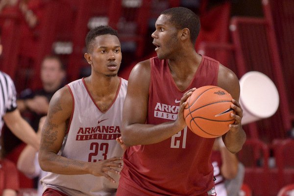 C.J. Jones (23) of white team guards Manuale Watkins (21) of red on Sunday Oct. 23, 2016 during the Red-White game at Bud Walton Arena in Fayetteiville.