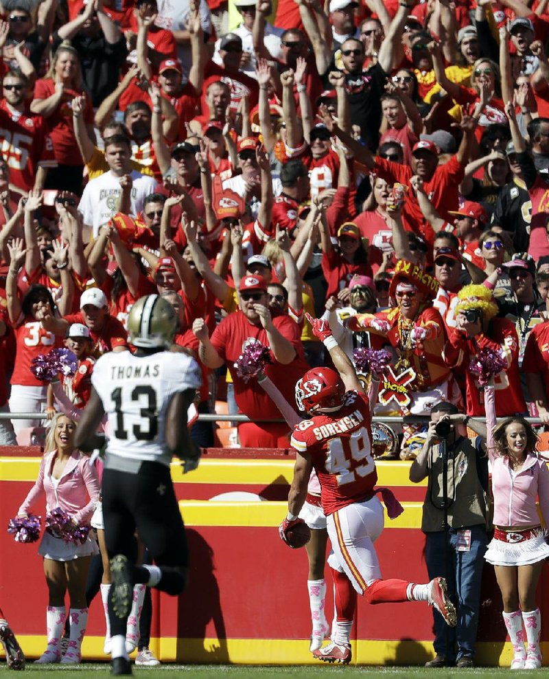 Kansas City Chiefs defensive back Daniel Sorensen (49) celebrates with fans after returning an interception 48 yards for a touchdown during the first half of Sunday’s game in Kansas City, Mo.