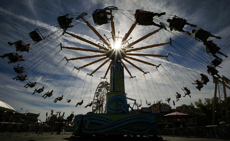 Fairgoers enjoy a spin on the Yolo ride on the last day of the Arkansas State Fair on Sunday in Little Rock.