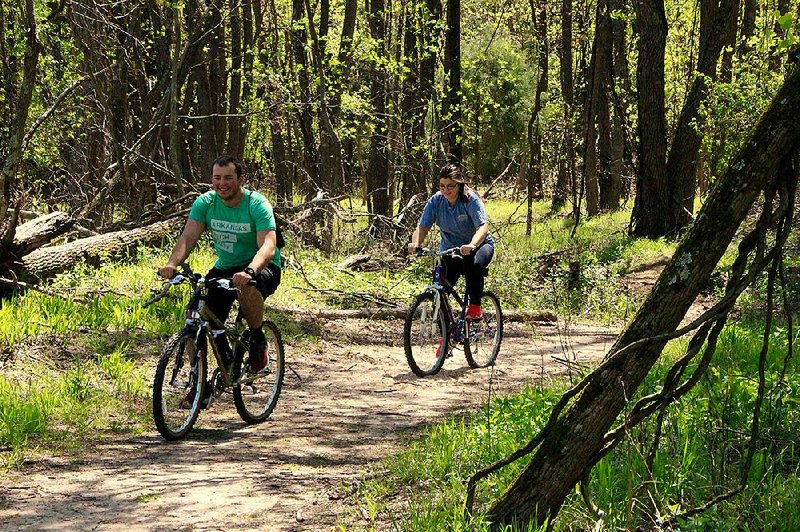 Bikers explore the hidden trail along the Arkansas River at Two Rivers Park in Little Rock.