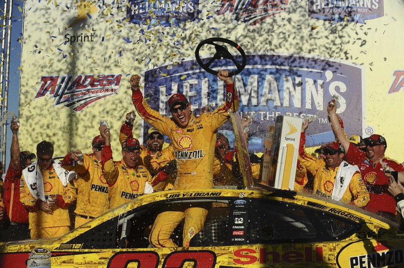 Joey Logano celebrates after winning the NASCAR Sprint Cup Series auto race auto race at Talladega Superspeedway, Sunday, Oct. 23, 2016, in Talladega, Ala. 